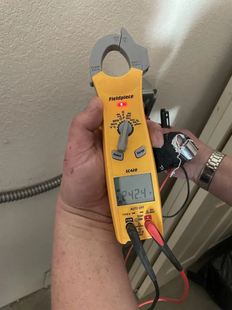 Voltage testing with clamp meter during Electrical Installation Services in Lawrence